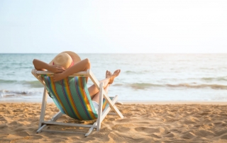 Photo of a Woman Relaxing by the Ocean. Click Here for 4 Fun Things to Do at the Beach!