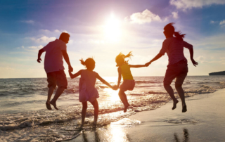 A family on the beach during their Pacific Northwest summer vacation to Oregon.