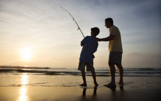 A father and son surf fishing, one of the numerous Newport, Oregon activities.