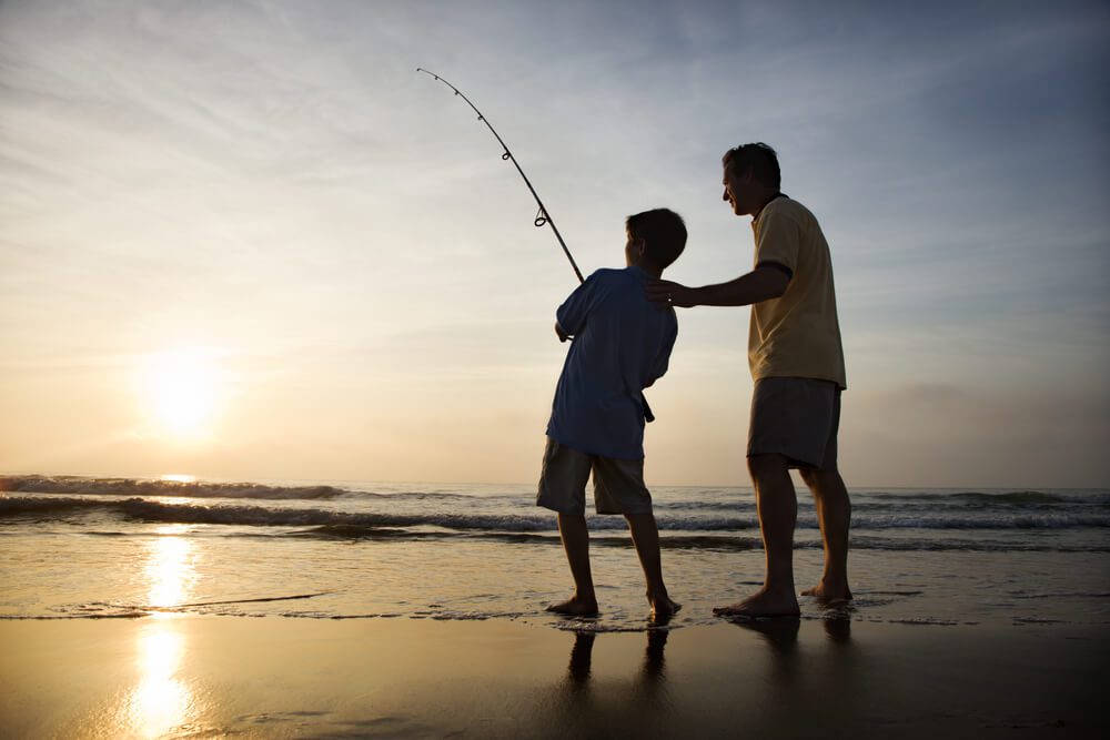 A father and son surf fishing, one of the numerous Newport, Oregon activities.