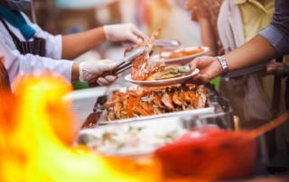 A server plating up food at the Newport Seafood and Wine Festival.