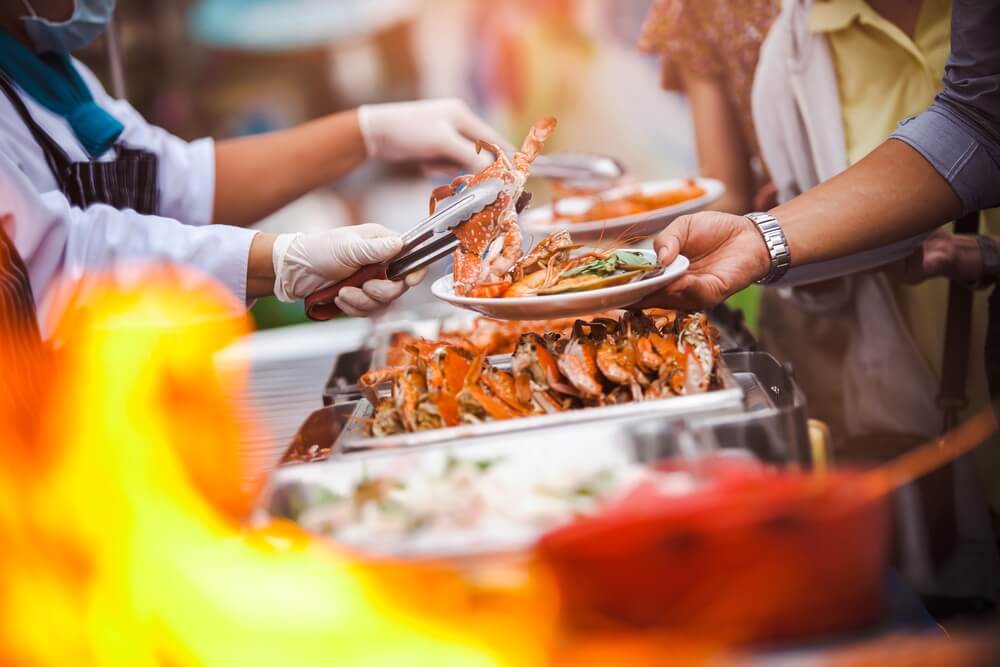 A server plating up food at the Newport Seafood and Wine Festival.