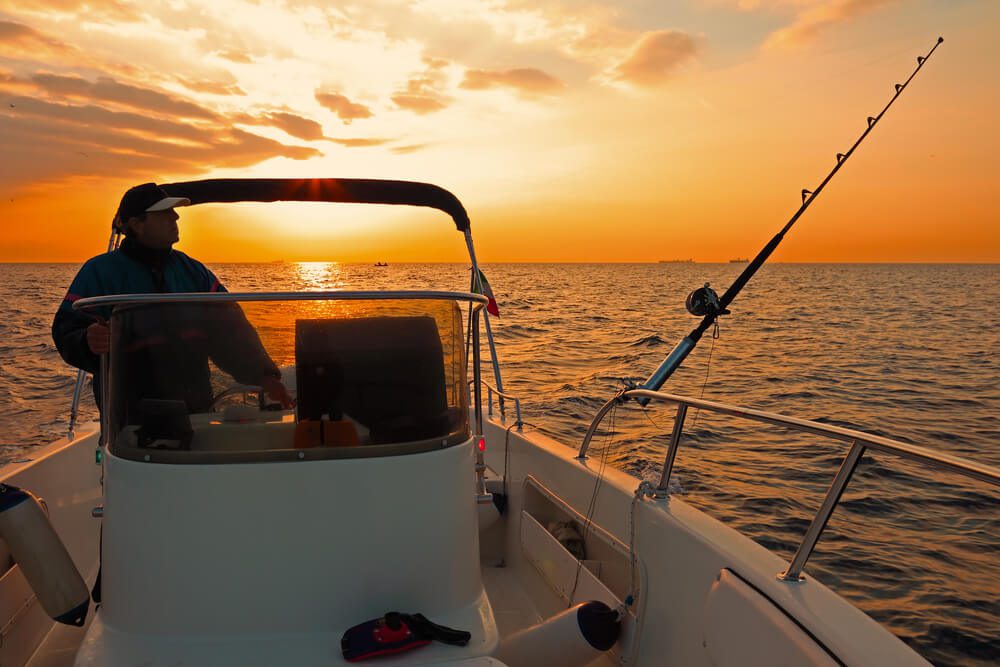 A person out fishing with one of the best Newport charters.