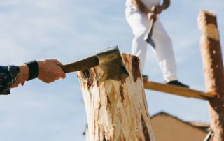 People competing in a logging competition at one of the summer events in Newport.