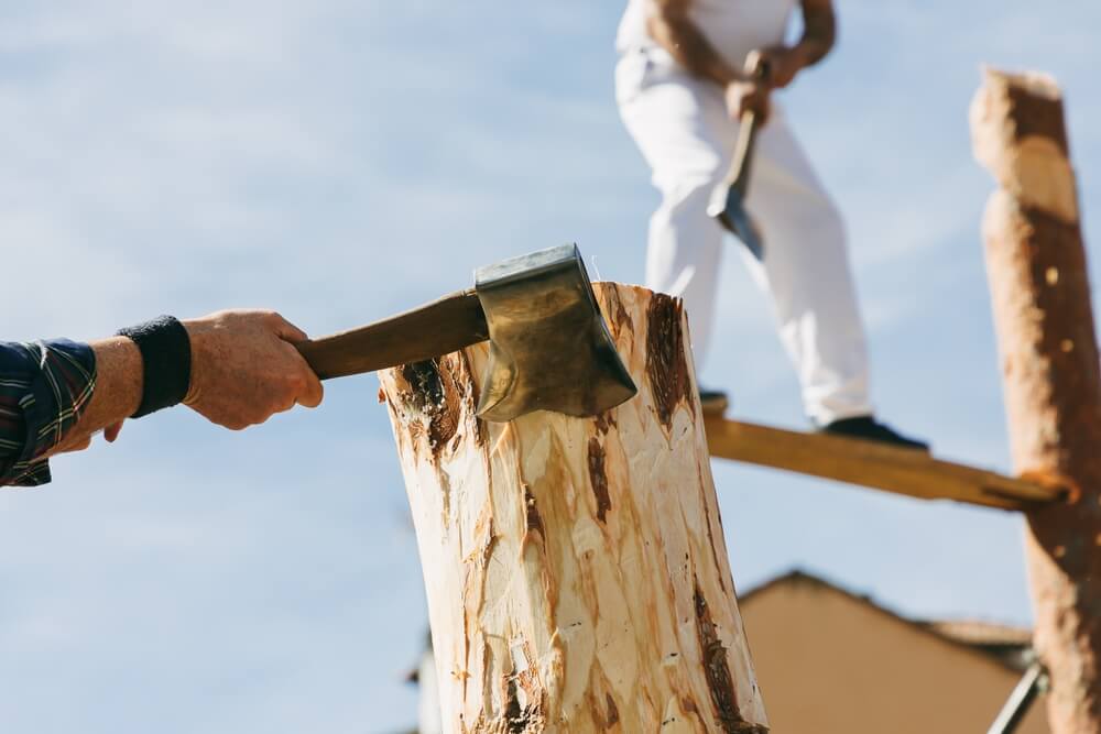 People competing in a logging competition at one of the summer events in Newport.