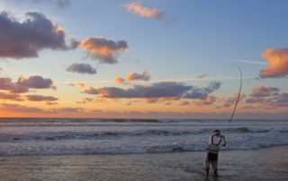 A man surf fishing on the Oregon coast near Newport.